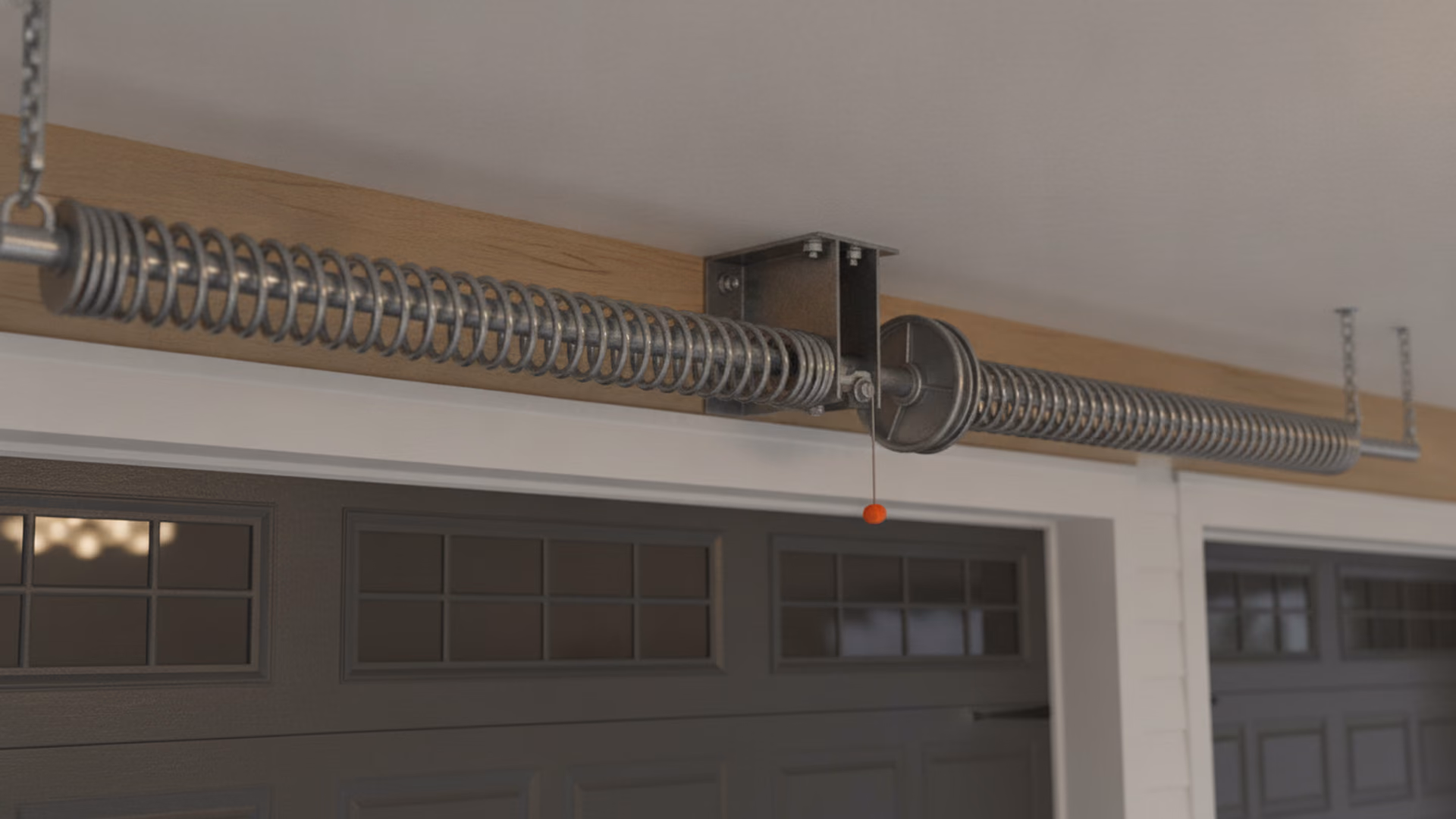 Torsion spring assembly mounted on its shaft above a garage door header — coiled spring, cable drum, and center bracket in sharp detail